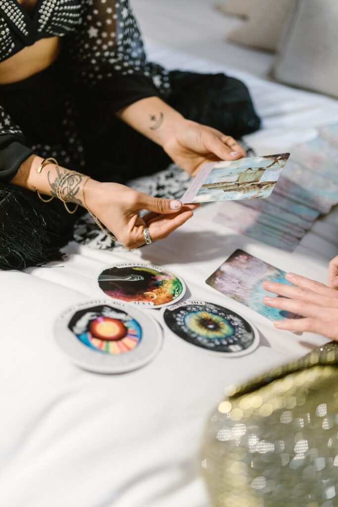 A woman holding tarot cards. Photo by rodnae productions on Pexels.