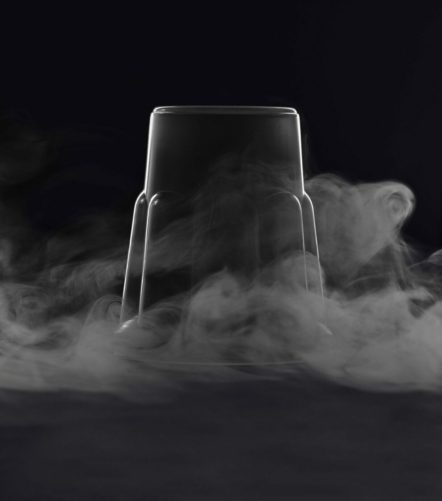 empty glass with smoke on a black background