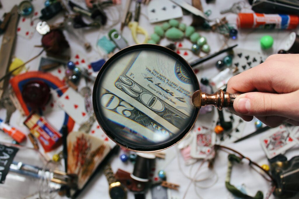twenty dollar bills under a magnifying glass. Photo by noelle otto on pexels.